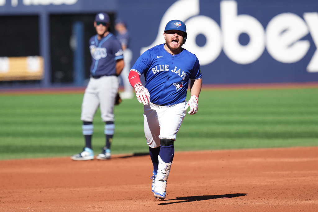 Toronto Blue Jays' Alejandro Kirk, right, rounds the bases after hitting a grand slam against the Tampa Bay Rays during first-inning baseball game action in Toronto, Sunday, Sept. 28, 2025. (Chris Young/The Canadian Press via AP)
