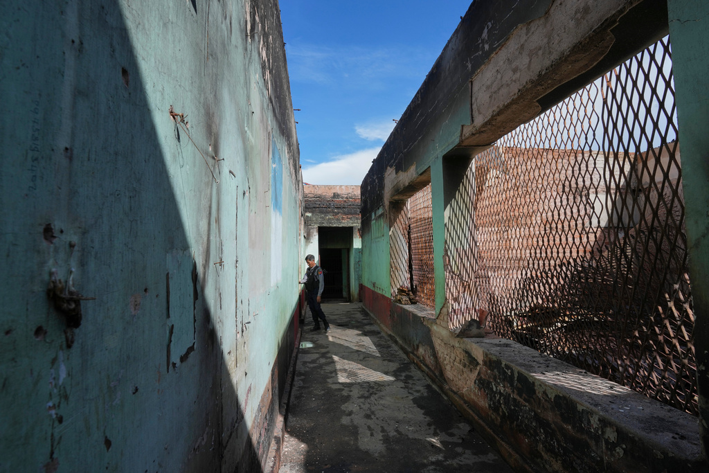 In this photo taken during a trip supervised by pro-military Myanmar media, a policeman walks inside a police station in Kyaukme, northern Shan State, Myanmar, Friday, Oct. 10, 2025. (AP Photo/Aung Shine Oo)