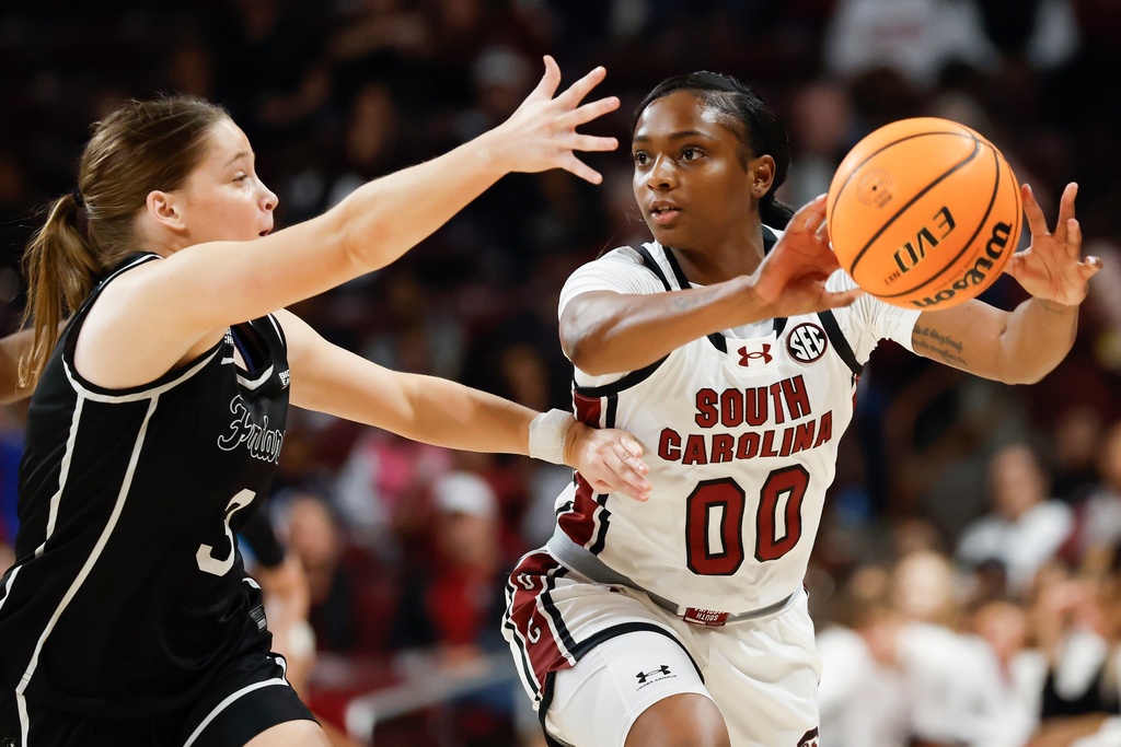 South Carolina guard Ta'Niya Latson (00) passes against Providence guard Orlagh Gormley during the first half of an NCAA college basketball game in Columbia, S.C., Sunday, Dec. 28, 2025. (AP Photo/Nell Redmond)