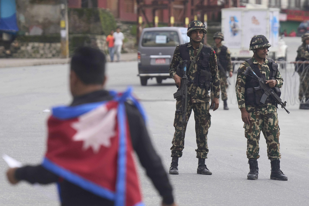 Members of the Nepalese army stand guard on a street of Kathmandu, Nepal, Thursday, Sept. 11, 2025. (AP Photo/Niranjan Shrestha)