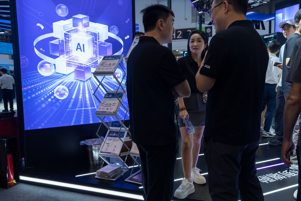 Visitors chat during the World AI Conference in Shanghai, July 17, 2026. (AP Photo/Ng Han Guan)