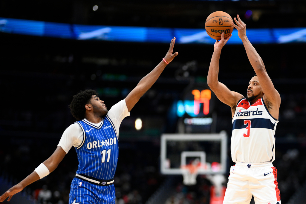 Washington Wizards guard CJ McCollum (3) shoots against Orlando Magic guard Jase Richardson (11) Washington Wizards guard CJ McCollum (3) during the first half of an NBA basketball game, Tuesday, Jan. 6, 2026, in Washington. (AP Photo/Nick Wass)