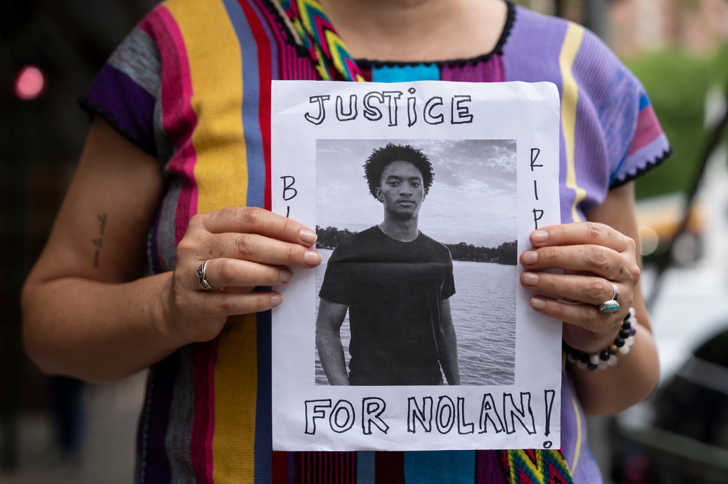 FILE - A person holds a picture of Nolan Xavier Wells during a news conference at National Action Network headquarters, Friday, July 10, 2026, in New York. (AP Photo/Yuki Iwamura, File)