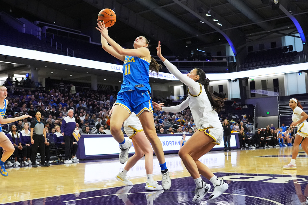 UCLA guard Gabriela Jaquez, left, drives to the basket as Northwestern guard Caroline Lau guards during the first half of an NCAA college basketball game in Evanston, Ill., Sunday, Jan. 25, 2026. (AP Photo/Nam Y. Huh)