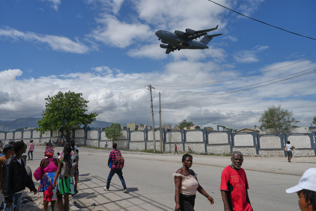 A U.S. military cargo plane prepares to land at the Toussaint Louverture airport as some people flee gang violence in Port-au-Prince, Haiti, Monday, May 11, 2026. (AP Photo/Odelyn Joseph)
