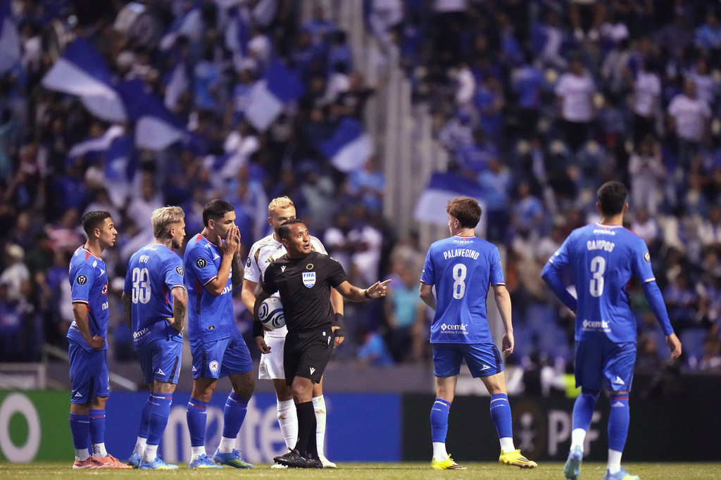 Referee Ivan Barton suspends the match due to discriminatory chants from the crowd during a CONCACAF Champions Cup quarterfinal second leg soccer match between Mexico's Cruz Azul and the United States' Los Angeles FC in Puebla, Mexico, Tuesday, April 14, 2026. (AP Photo/Eduardo Verdugo)