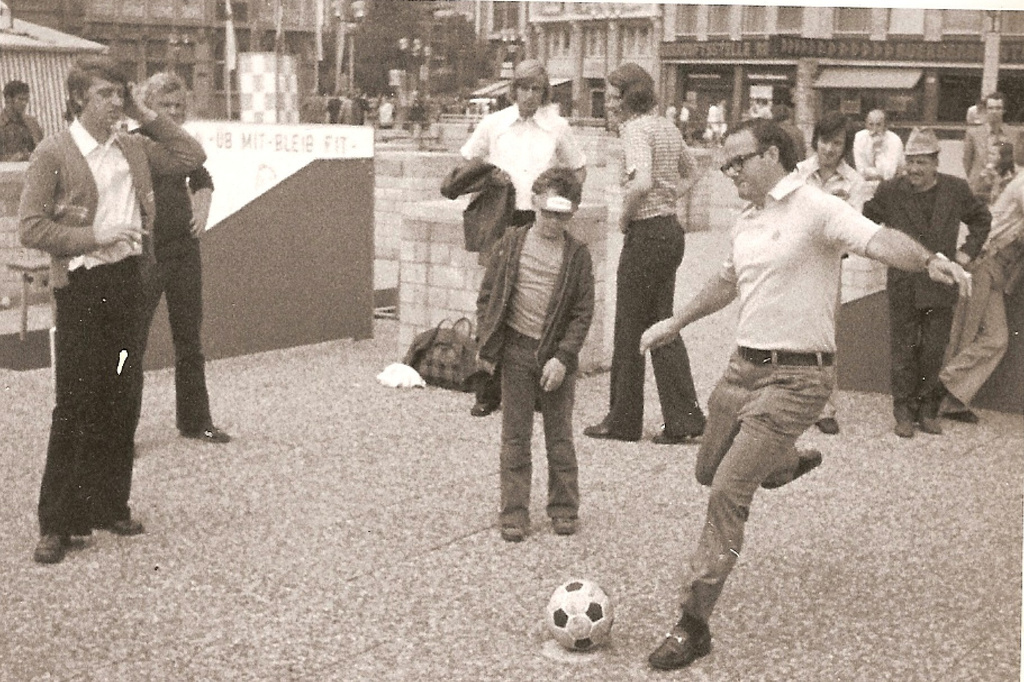 In this photo provided by the Hunt family, Lamar Hunt kicks a ball at a World Cup fan plaza in Dusseldorf, Germany, during the 1974 soccer tournament. (Hunt Family via AP)