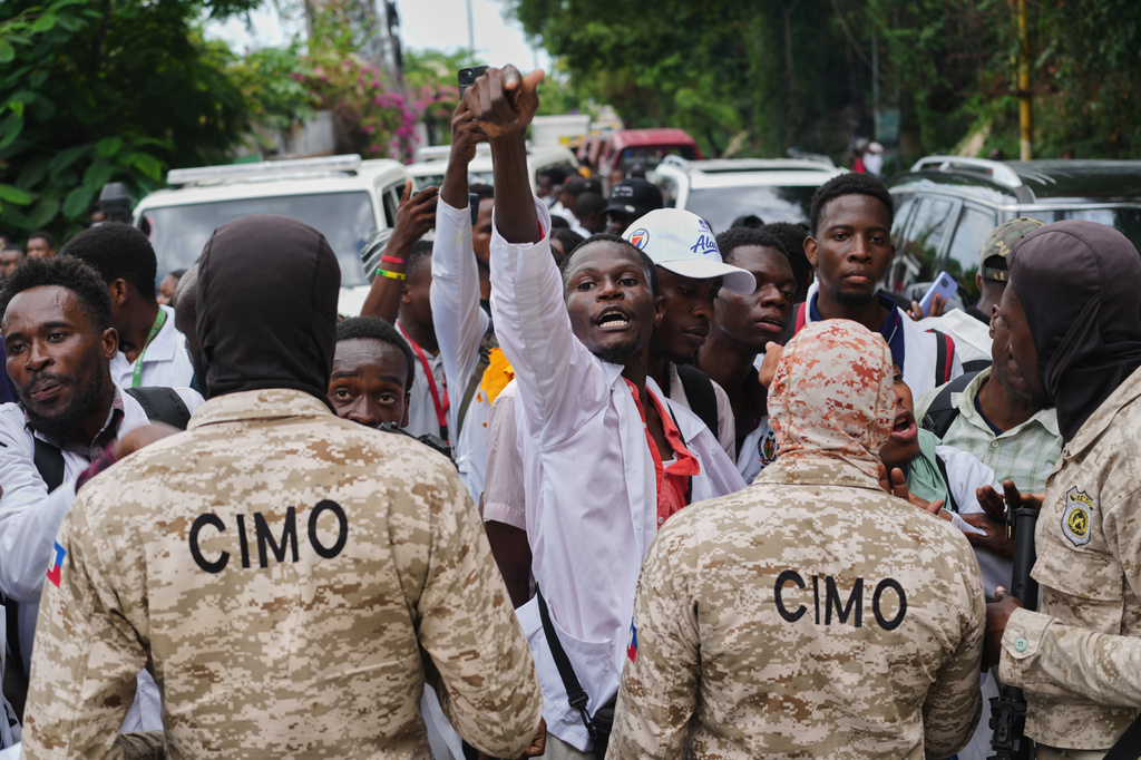 Police officers block medical students from advancing during a protest demanding the reopening of the General Hospital in Port-au-Prince, Haiti, Wednesday, July 1, 2026. (AP Photo/Odelyn Joseph)