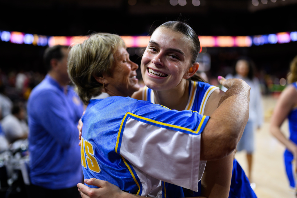 UCLA forward Gabriela Jaquez, right, hugs a fan after an NCAA college basketball game against Southern California, Sunday, March 1, 2026, in Los Angeles. (AP Photo/William Liang)