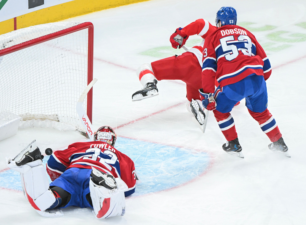 Montreal Canadiens goaltender Jacob Fowler (32) is scored on by Detroit Red Wings' Lucas Raymond, centre, as Canadiens' Noah Dobson (53) defends during the second period of an NHL hockey game in Montreal, Saturday, Jan. 10, 2026. (Graham Hughes/The Canadian Press via AP)