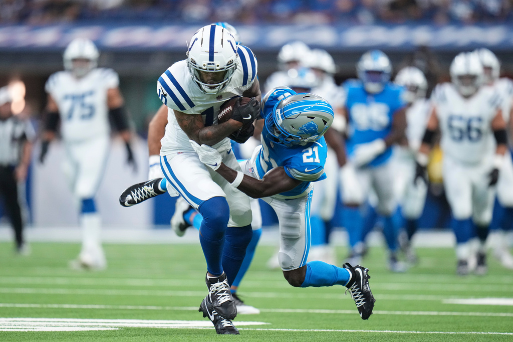 Indianapolis Colts wide receiver Keenan Allen (10) is tackled by Detroit Lions cornerback Roger McCreary (21) during the first half of a preseason NFL football game in Indianapolis, Saturday, Aug. 29, 2026. (AP Photo/Jeff Roberson)
