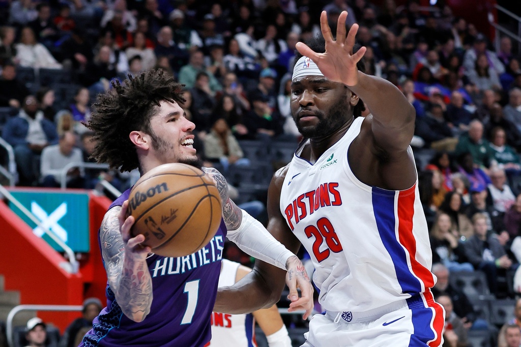 Charlotte Hornets guard LaMelo Ball (1) looks to pass the ball against Detroit Pistons forward Isaiah Stewart (28) during the first half of an NBA basketball game, Saturday, Dec. 20, 2025, in Detroit. (AP Photo/Duane Burleson)