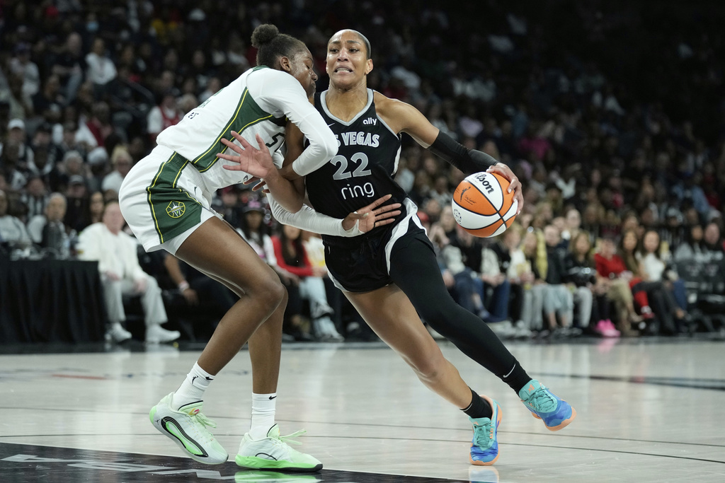 Las Vegas Aces center A'ja Wilson (22) drives against Seattle Storm center Dominique Malonga (14) during the second half of Game 3 in the first round of the WNBA basketball playoffs Thursday, Sept. 18, 2025, in Las Vegas. (AP Photo/John Locher)