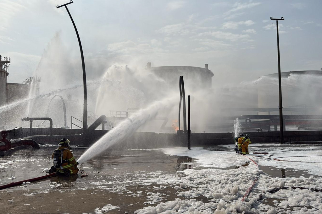 FILE - This image released by Bahrain's Interior Ministry shows firefighters extinguishing flames after an Iranian projectile struck an industrial area in Ma'ameer, Bahrain, March 9, 2026. (Bahrain Interior Ministry via AP, File)