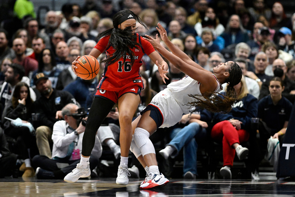 St. John's forward Daniela Abies, left, fouls UConn forward Sarah Strong, right, in the first half of an NCAA college basketball game, Wednesday, Jan. 7, 2026, in Hartford, Conn. (AP Photo/Jessica Hill)
