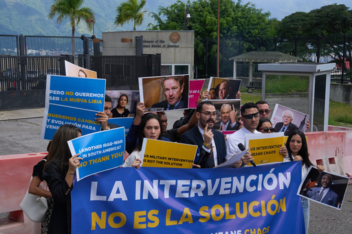 Gabriel Cabrera, president of the Venezuelan Youth Center for Democracy, gives a statement outside of the U.S. embassy with members of the organization holding signs that read in Spanish "Intervention is not the solution," in reference to U.S. warships operating in the Caribbean, in Caracas, Venezuela, Monday, Oct. 27, 2025. (AP Photo/Ariana Cubillos) Gabriel Cabrera, president of the Venezuelan Youth Center for Democracy, gives a statement outside of the U.S. embassy with members of the organization holding signs that read in Spanish "Intervention is not the solution," in reference to U.S. warships operating in the Caribbean, in Caracas, Venezuela, Monday, Oct. 27, 2025. (AP Photo/Ariana Cubillos)