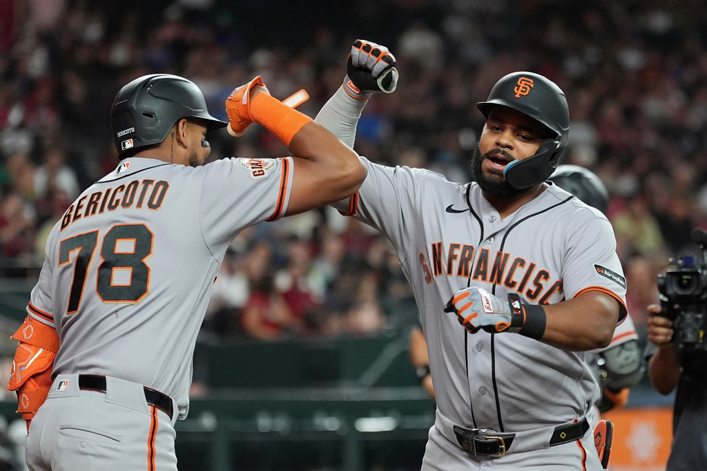 San Francisco Giants' Heliot Ramos, right, celebrates his home run against the Arizona Diamondbacks with Giants' Victor Bericoto (78) during the fifth inning of a baseball game, Wednesday, July 1, 2026, in Phoenix. (AP Photo/Ross D. Franklin)