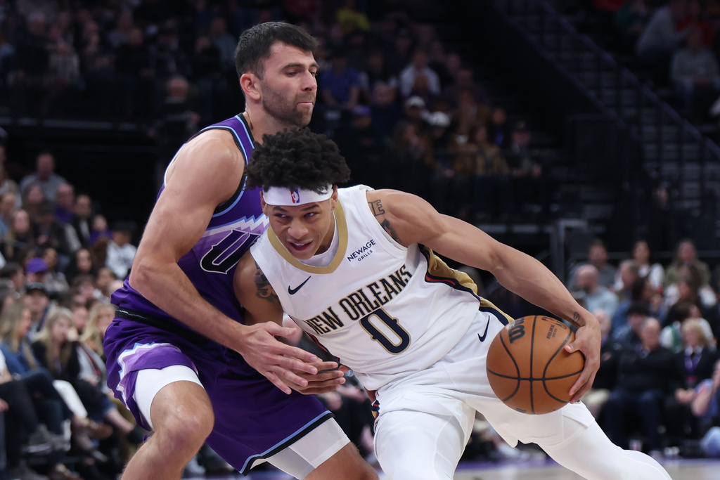 New Orleans Pelicans guard Jeremiah Fears (0) drives with the ball against Utah Jazz guard John Konchar, left, during the first half of an NBA basketball game, Saturday, Feb. 28, 2026, in Salt Lake City. (AP Photo/Rob Gray)