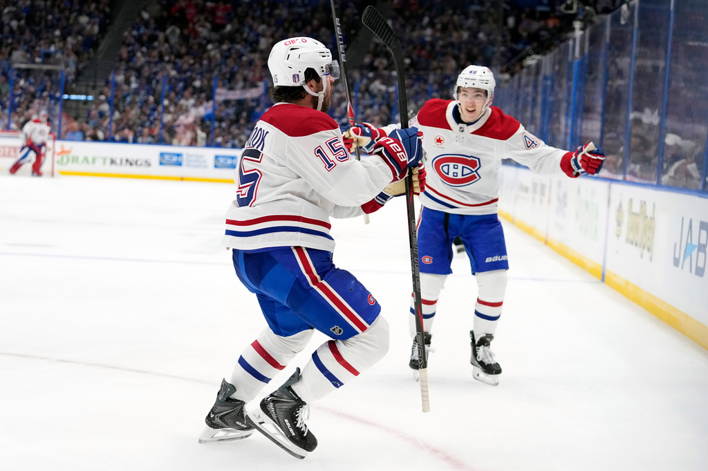 Montréal Canadiens center Alex Newhook (15) celebrates his goal against the Tampa Bay Lightning with defenseman Lane Hutson (48) during the third period in Game 7 of an NHL hockey Stanley Cup first-round playoff series, Sunday, May 3, 2026, in Tampa, Fla. (AP Photo/Chris O'Meara)