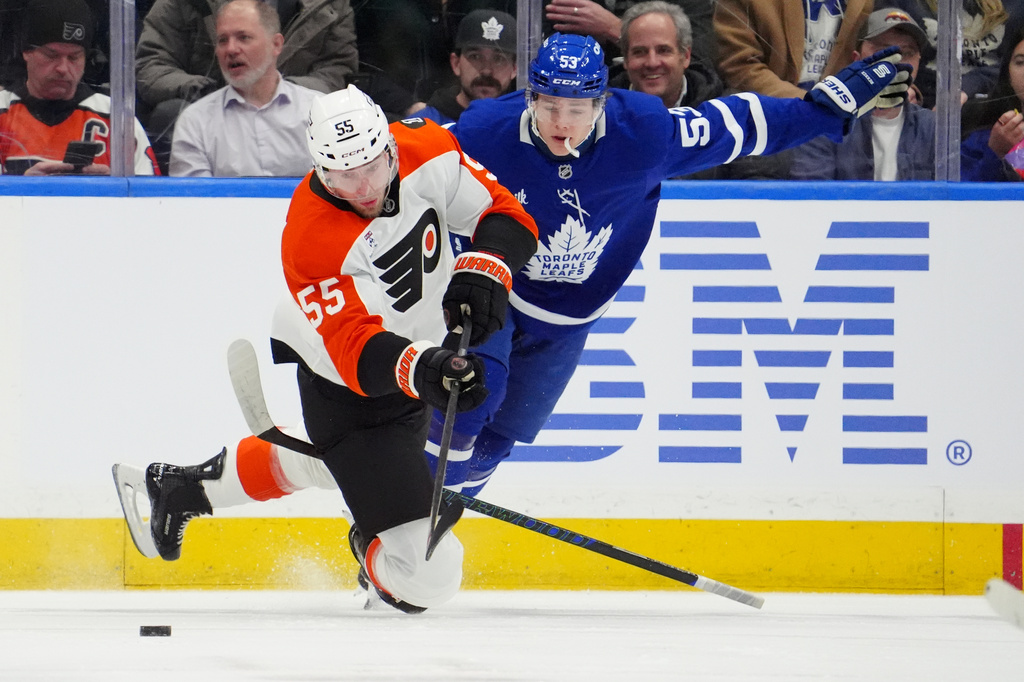 Toronto Maple Leafs' Easton Cowan (53) catches a penalty for tripping Philadelphia Flyers' Rasmus Ristolainen (55) during first-period NHL hockey game action in Toronto, Monday, March 2, 2026. (Frank Gunn/The Canadian Press via AP)