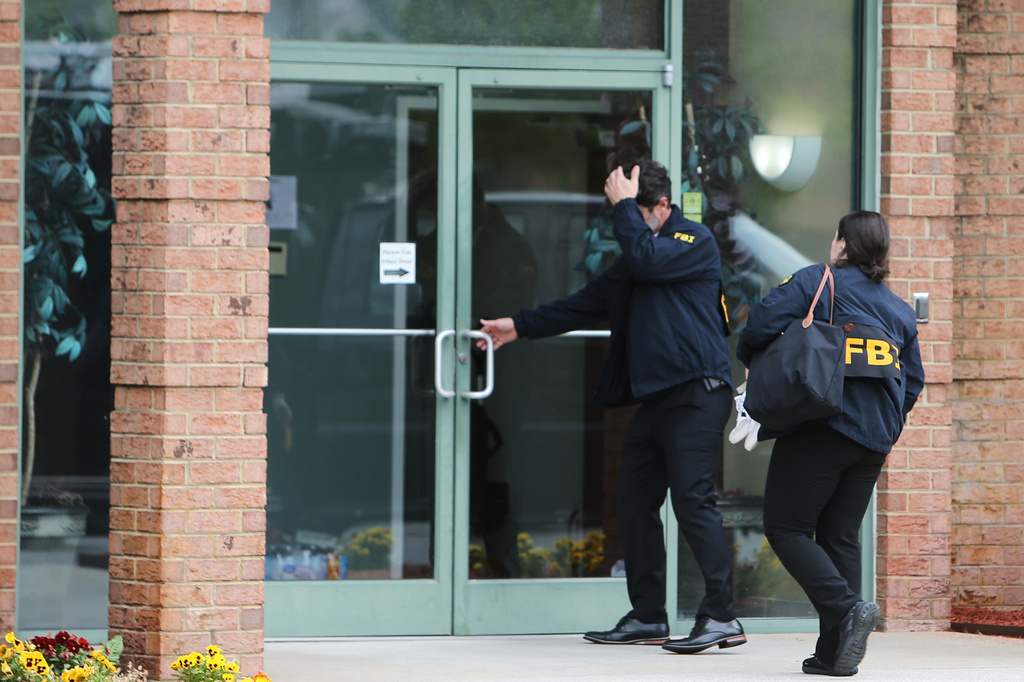 FBI personnel enter a building in Portsmouth, Va., Wednesday, May 6, 2026. (AP Photo/John Clark)