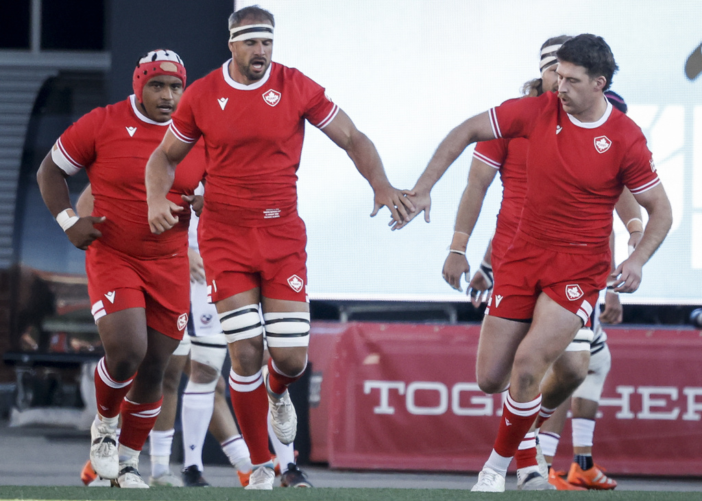 Canada's Tyler Ardron, center, celebrates after his try with teammates during first-half Pacific Nations Cup rugby match action against the United States in Calgary, Alberta, Friday, Aug. 22, 2025. (Jeff McIntosh/The Canadian Press via AP)