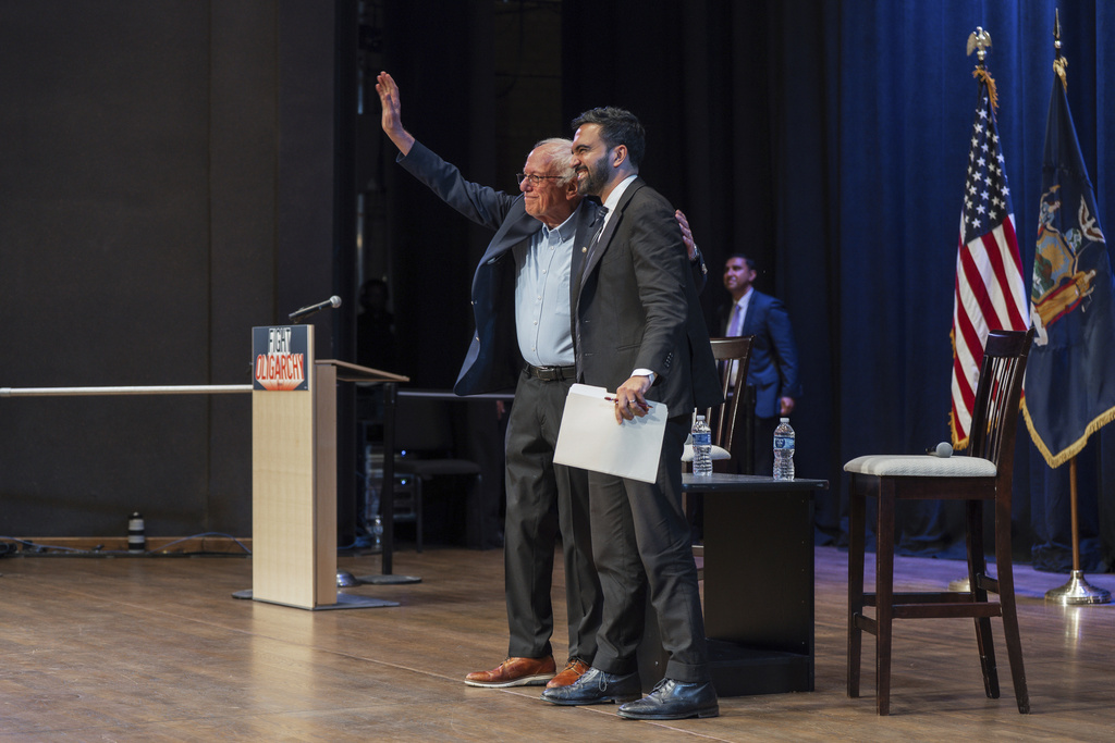 Sen. Bernie Sanders, I-Vt., waves to attendees with New York City mayoral candidate Zohran Mamdani during a town hall on Saturday, Sept, 6, 2025, in New York. (AP Photo/Olga Fedorova)
