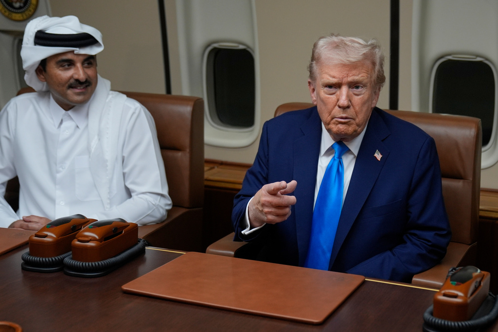 President Donald Trump, right, meets with Emir of Qatar Sheikh Tamim bin Hamad al-Thani aboard Air Force One at Al Udeid Air Base in Doha, Qatar, Saturday, Oct. 25, 2025. (AP Photo/Mark Schiefelbein)