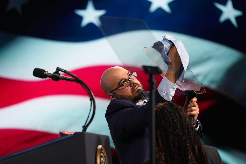 FILE - Gabriel Perez cleans the teleprompter before President Donald Trump speaks at the Future Investment Initiative Institute's summit, March 27, 2026, in Miami Beach, Fla. (AP Photo/Mark Schiefelbein, File)