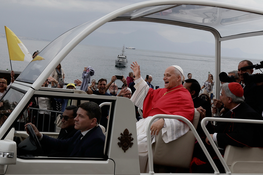 Pope Leo XIV rides in the popemobile with Cardinal Domenico Battaglia in front of Mount Vesuvius, Friday, May 8, 2026, in Naples, during a one-day pastoral visit to Pompeii and Naples. (AP Photo/Salvatore Laporta)