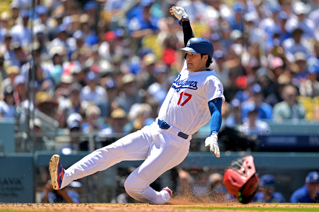 Los Angeles Dodgers' Shohei Ohtani scores on a ground out by Los Angeles Dodgers right fielder Kyle Tucker (not shown) during the third inning of a baseball game against the Los Angeles Angels, Sunday, June 7, 2026, in Los Angeles. (AP Photo/Jayne Kamin-Oncea)