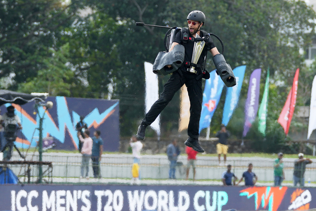 An acrobat flies with the T20 World Cup cricket trophy around the stadium before the start of the opening match between Netherlands and Pakistan in Colombo, Sri Lanka, Saturday, Feb. 7, 2026. (AP Photo/Eranga Jayawardena)
