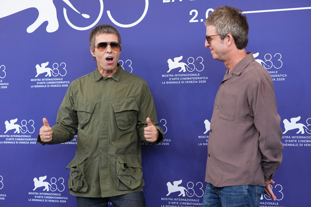 Liam Gallagher, left, and Noel Gallagher pose for photographers at the photo call for the film 'Oasis: Don't Look Back In Anger' during the 83rd edition of the Venice Film Festival in Venice, Italy, on Saturday, Sept. 5, 2026. (Photo by Scott A Garfitt/Invision/AP)