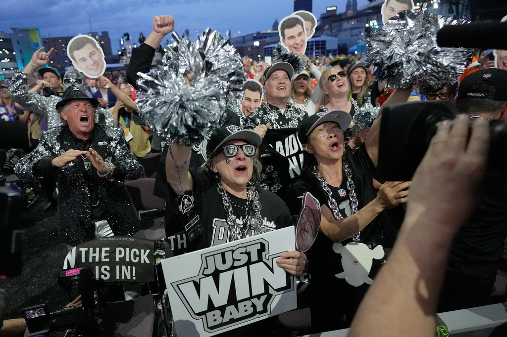 Las Vegas Raiders fans celebrate after Indiana quarterback Fernando Mendoza was chosen by the Las Vegas Raiders with the first overall pick during the first round of the NFL football draft, Thursday, April 23, 2026, in Pittsburgh. (AP Photo/Sue Ogrocki)