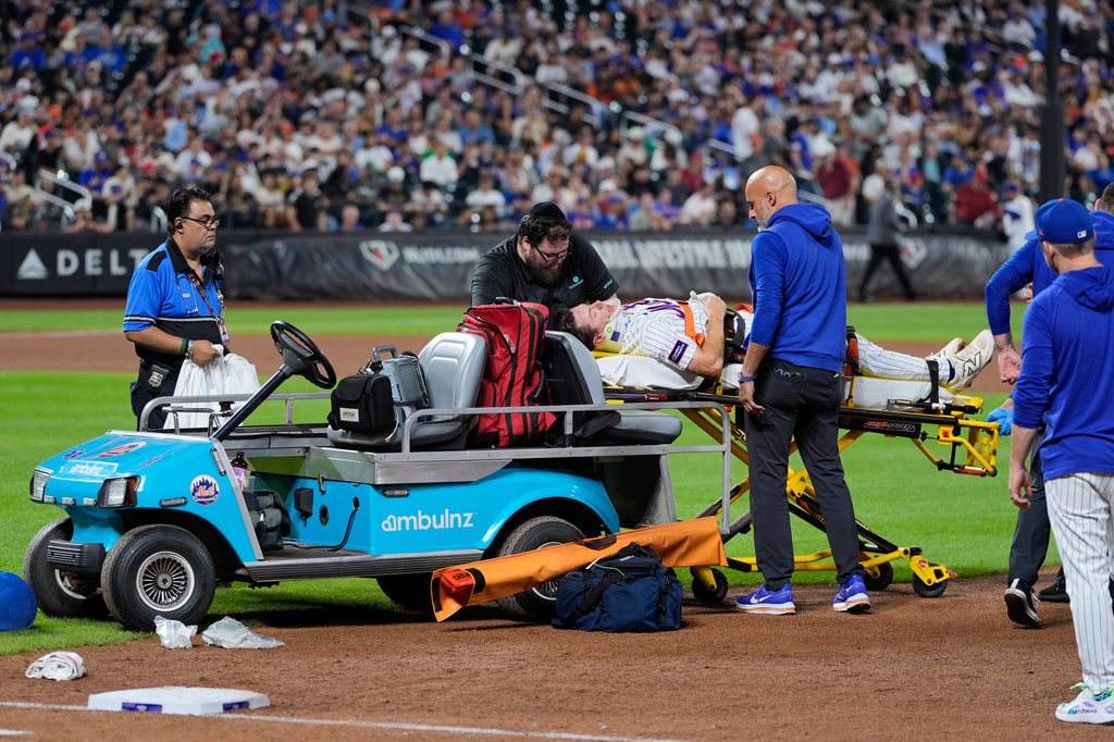 New York Mets first baseman Jared Young is brought off the field on a stretcher after colliding with pitcher Nolan McLean during the sixth inning of a baseball game against the Philadelphia Phillies, Thursday, Sept. 17, 2026, in New York. (AP Photo/Seth Wenig)