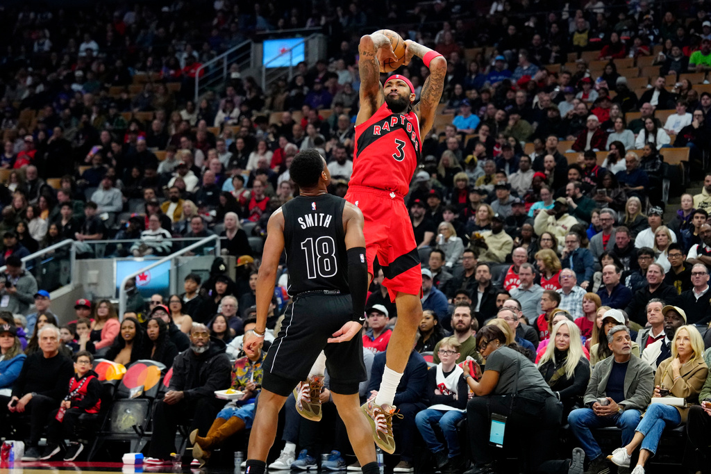 Toronto Raptors forward Brandon Ingram (3) goes up to shoot over Brooklyn Nets guard Malachi Smith (18) during first-half NBA basketball game action in Toronto, Sunday, April 12, 2026. (Frank Gunn/The Canadian Press via AP)