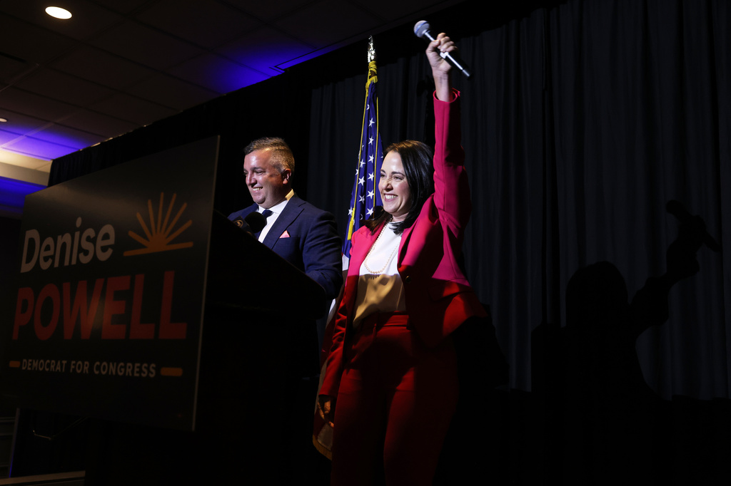 Denise Powell, right, candidate for the Democratic nomination to the House of Representatives in Nebraska's second district, cheers during an election night watch party Tuesday, May 12, 2026, in Omaha, Neb. (AP Photo/Rebecca S. Gratz)