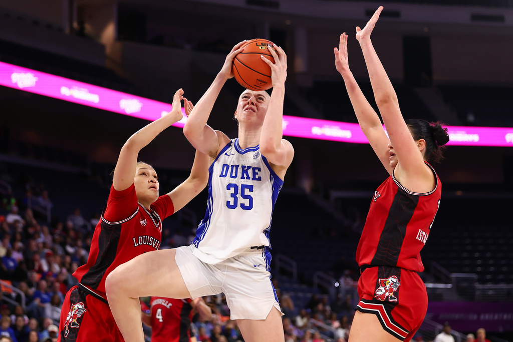 Duke forward Toby Fournier (35) shoots against Louisville guard Imari Berry, left, and forward Elif Istanbulluoglu, right, during the second half of an NCAA college basketball game in the championship of the Atlantic Coast Conference tournament, Sunday, March 8, 2026, in Duluth, Ga. (AP Photo/Colin Hubbard)