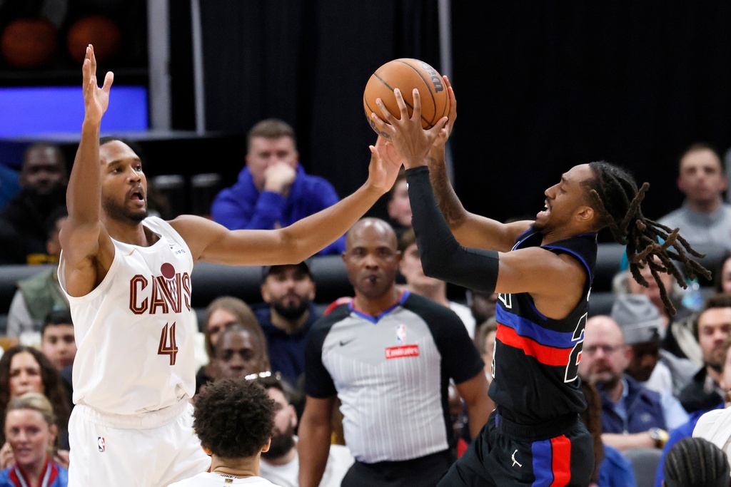 Detroit Pistons guard Daniss Jenkins, right, goes up for a shot against Cleveland Cavaliers center Evan Mobley (4) during the second half of an NBA basketball game Friday, Feb. 27, 2026, in Detroit. (AP Photo/Duane Burleson)