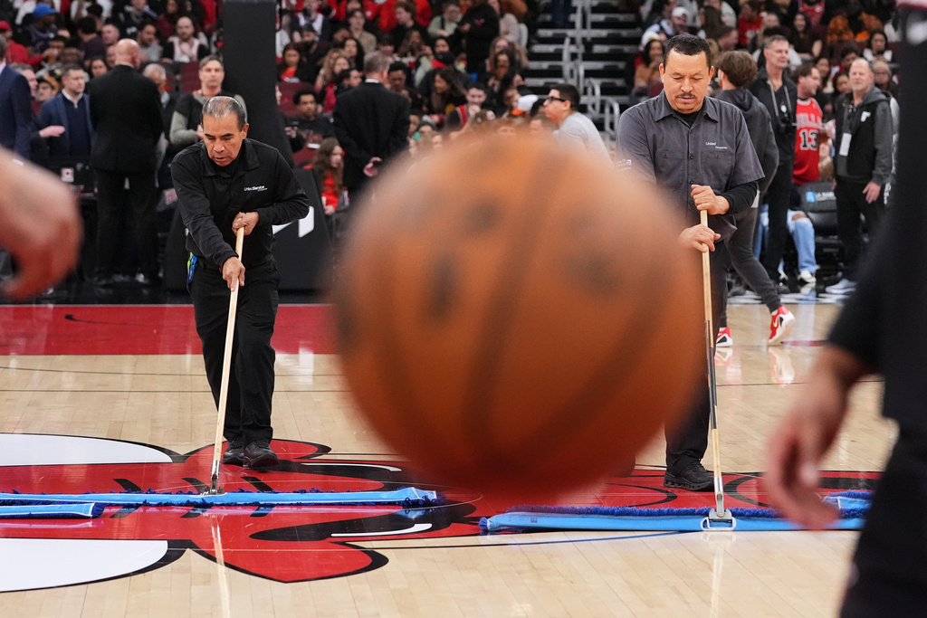 United center employees cleans the court during a delay before an NBA basketball game against the Miami Heat in Chicago, Thursday, Jan. 8, 2026. (AP Photo/Nam Y. Huh)