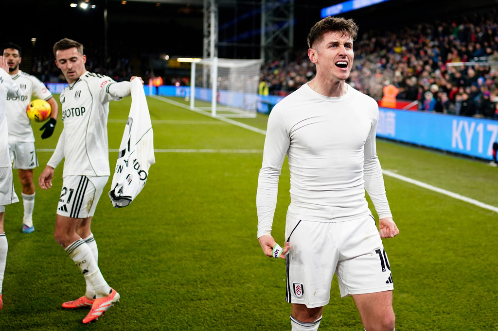 Fulham's Tom Cairney (right) celebrates after scoring his sides first goal during their English Premier League soccer match against Crystal Palace in London, Thursday, Jan. 1, 2025. (Jordan Pettitt/PA via AP)