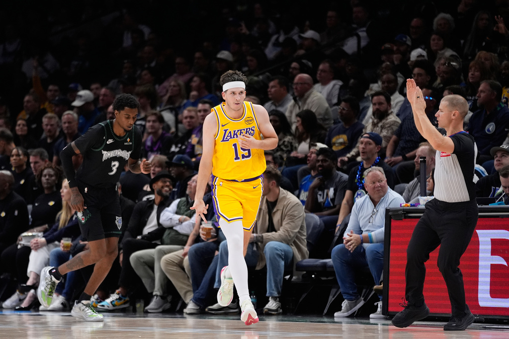 Los Angeles Lakers guard Austin Reaves (15) gestures after making a 3-point shot during the first half of an NBA basketball game against the Minnesota Timberwolves, Wednesday, Oct. 29, 2025, in Minneapolis. (AP Photo/Abbie Parr)