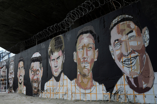 FILE - A mural features the faces of the young soccer players who died in a fire at the Flamengo club training center in Rio de Janeiro, Brazil, Feb. 7, 2020. (AP Photo/Silvia Izquierdo, FILE) FILE - A mural features the faces of the young soccer players who died in a fire at the Flamengo club training center in Rio de Janeiro, Brazil, Feb. 7, 2020. (AP Photo/Silvia Izquierdo, FILE)