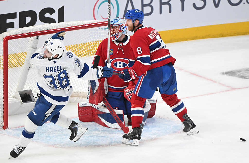 Montreal Canadiens goaltender Jakub Dobes (75) and defenceman Mike Matheson (8) look back on their goal after being scored Tampa Bay Lightning's Brandon Hagel (38) during third period of an NHL playoff hockey action in Montreal, Sunday, April 26, 2026. (Graham Hughes/The Canadian Press, via AP)