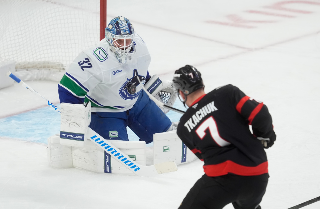 Ottawa Senators left wing Brady Tkachuk (7) shoots on Vancouver Canucks goaltender Kevin Lankinen (32) during first period NHL action in Ottawa, Tuesday, Jan. 13, 2026. (Adrian Wyld/The Canadian Press via AP)