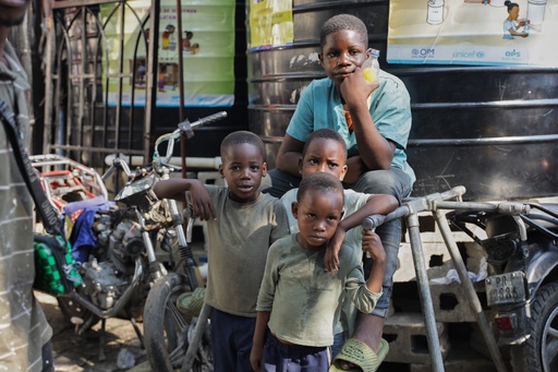 Children look at students attending school at a shelter for families displaced by gang violence in Port-au-Prince, Haiti, Tuesday, Oct. 7, 2025. (AP Photo/Patrice Noel) Children look at students attending school at a shelter for families displaced by gang violence in Port-au-Prince, Haiti, Tuesday, Oct. 7, 2025. (AP Photo/Patrice Noel)