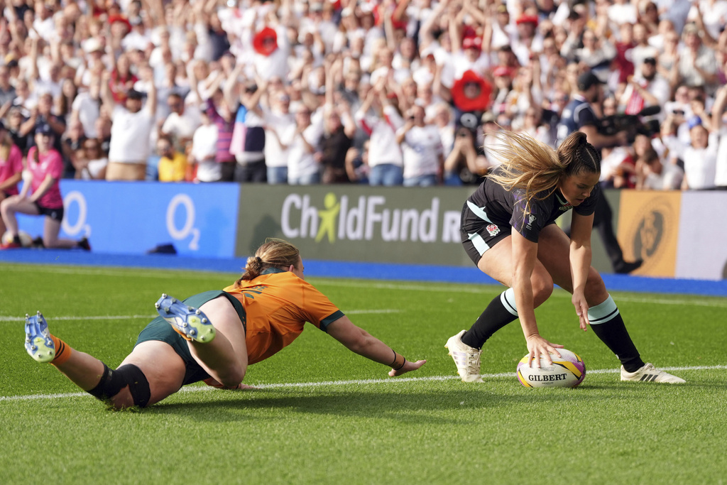 England's Jess Breach, right, scores her sides first try of the game during the Women's Rugby World Cup 2025 Pool A match between England and Australia at the Brighton and Hove Albion Stadium, in Brighton and Hove, England, Saturday, Sept. 6, 2025. (Ben Whitley/PA via AP)