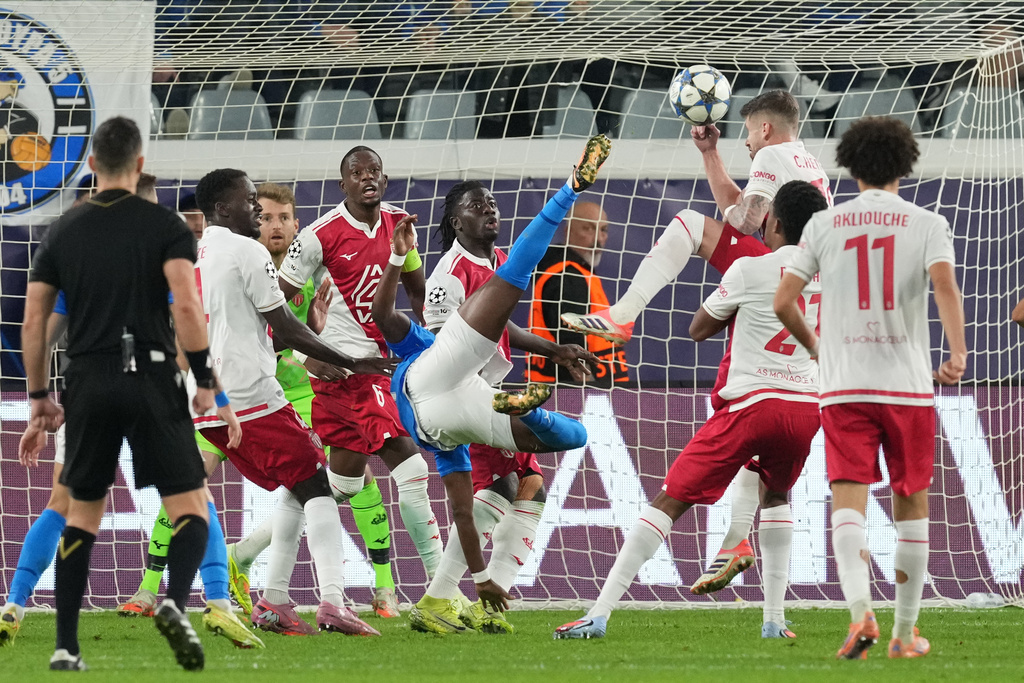 Pafos' Mons Bassouamina, centre, makes an attempt to score during the Champions League opening phase soccer match between Pafos FC and AS Monaco in Limassol, Cyprus, Wednesday, Nov. 26, 2025. (AP Photo/Petros Karadjias)