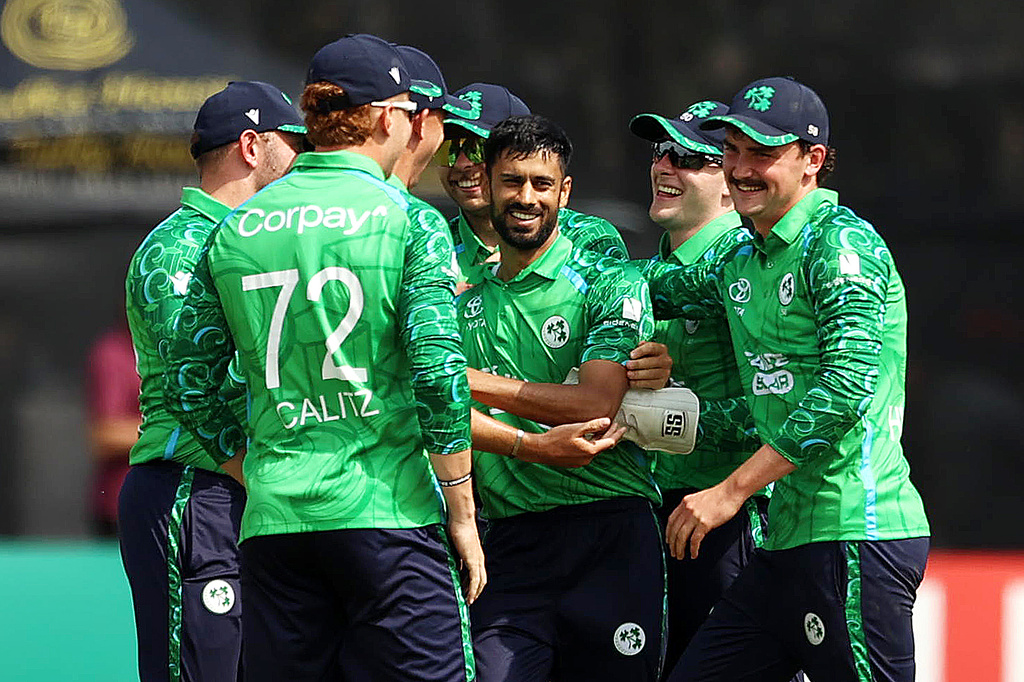 Ireland's Jai Moondra, center, celebrates with team-mates after bowling out India's Sanju Samson during the first T20I test match at Stormont, Belfast, Northern Ireland, Friday June 26, 2026. (Liam McBurney/PA via AP)