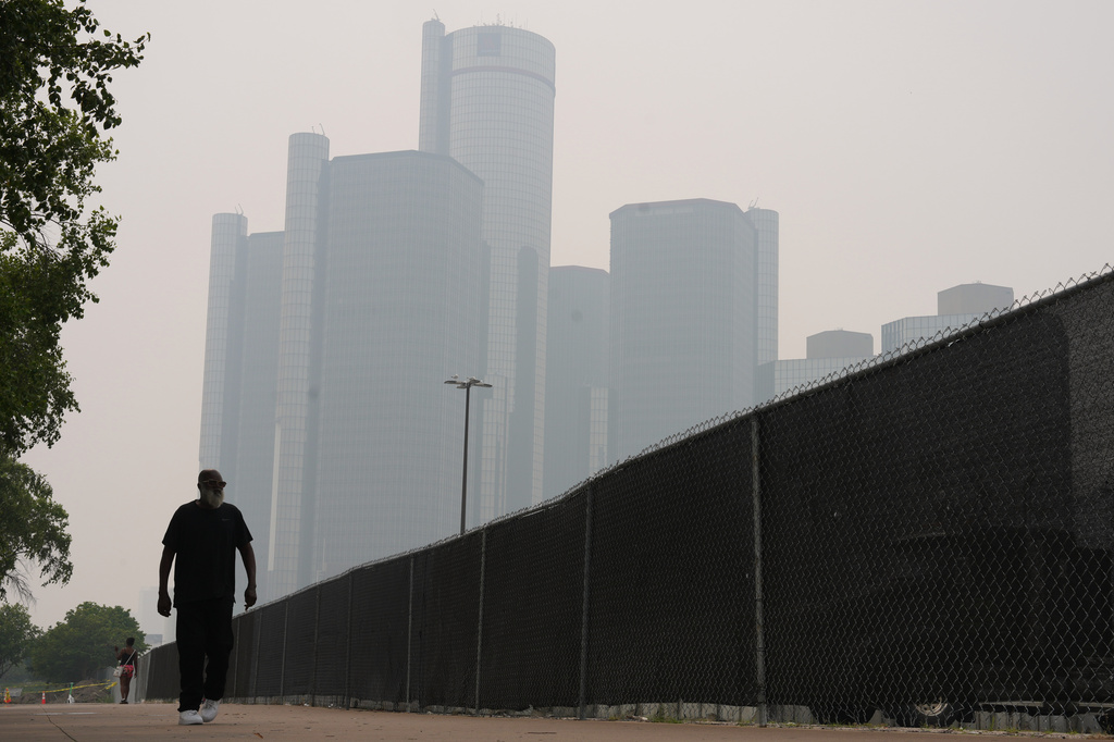 Jimmy Tyner walks along the Detroit River during poor air quality due to smoke from Canadian wildfires Thursday, July 16, 2026, in Detroit. (AP Photo/Paul Sancya)